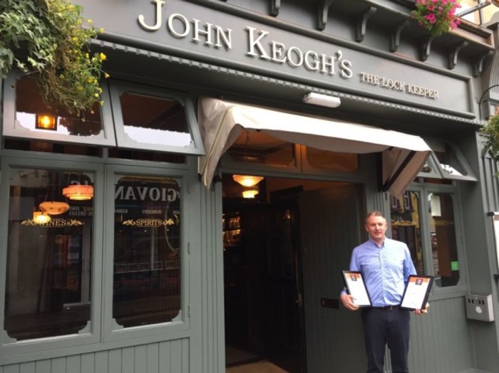 Matt Hall pictured outside John Keoghs The Lockkeeper with the two Irsih Pub Awards.
