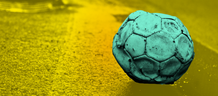 Design for Tough Start project - An old football that has too little air in it sitting on the side of the road.