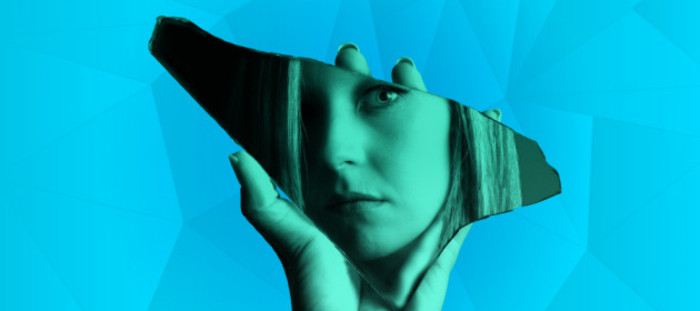 Design for SILENT TREATMENT project - Woman holding a broken mirror with her reflection in it.