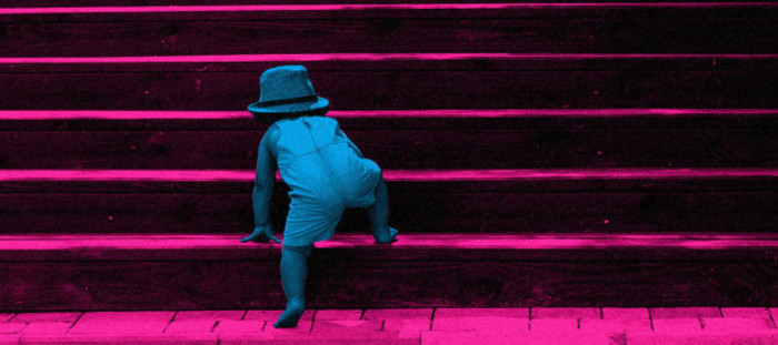 Design for DELAYED DELIVERY - Toddler wearing a summer outfit and hat attempting to climb a series of steps.