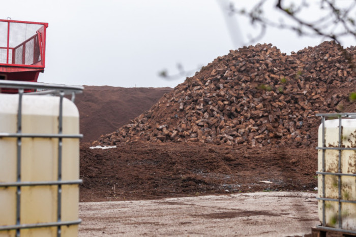 Photo of large piles of harvested peat