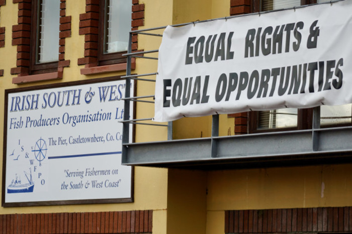 Building with a sign - Irish South &amp; West Fish Producers Organisation Ltd - The Pier, Castletownbere, Co Cork - with the slogan: Serving Fishermen on the South &amp; West Coast. Another sign on a balcony says: Equal Rights &amp; Equal Opportunities.