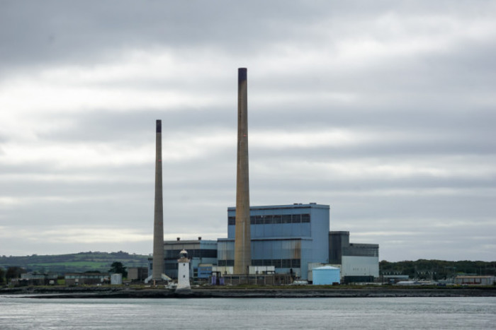 View of a power station with tall dark grey chimney stacks