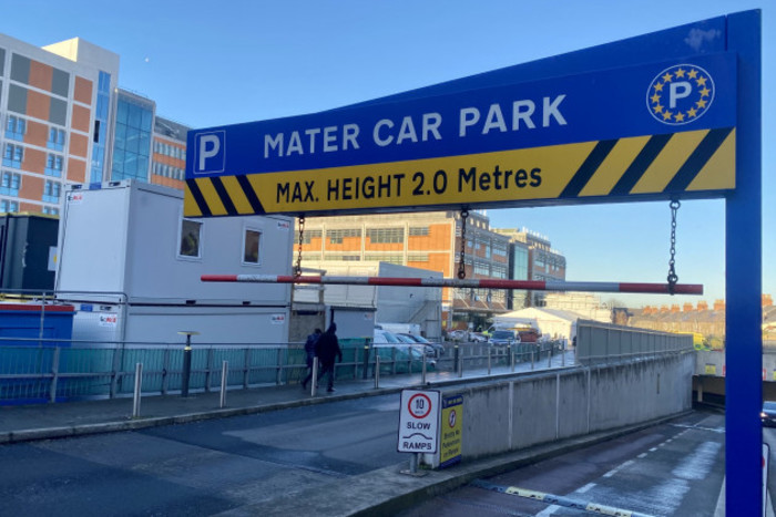 Overhead sign at the entrance to the car park that reads - Mater Car Park, Max. Height 2.0 Metres. The hospital can be seen in the background.