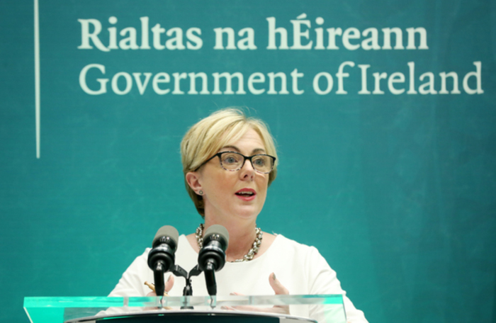 Regina Doherty at a Government of Ireland - Rialtas na h&Eacute;ireann - event speaking at a podium