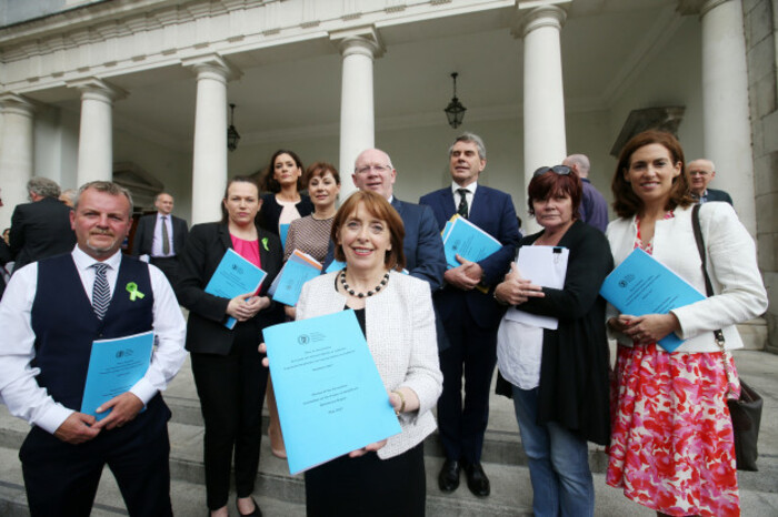 Group of politicians holding the 10-year strategy report 