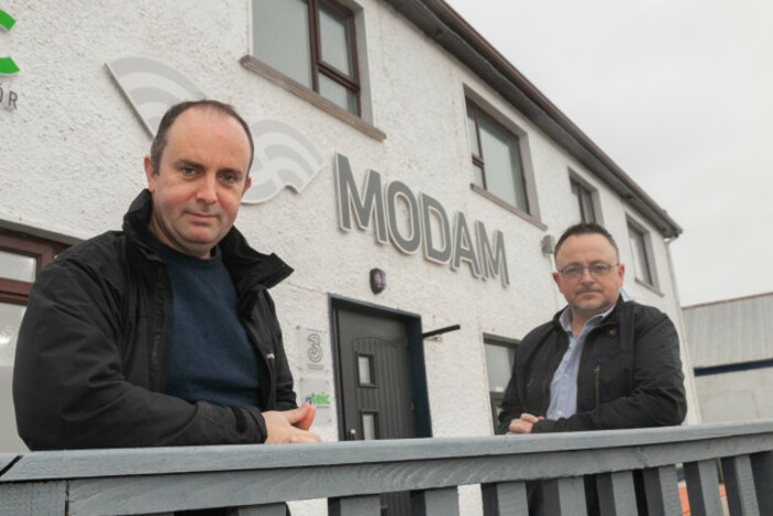 Seamus Bonner on the left in a navy jacket in front of a white building