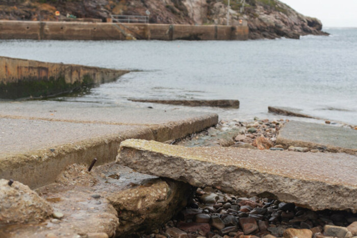 Large pieces of broken grey concrete from a slipway along the seafront