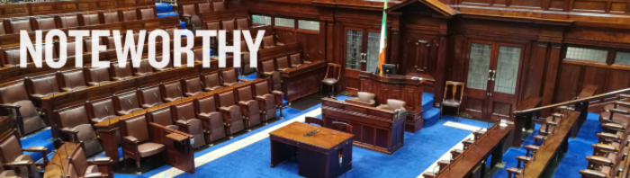 Empty D&aacute;il chamber with the Irish flag near the centre with Noteworthy written in the foreground.