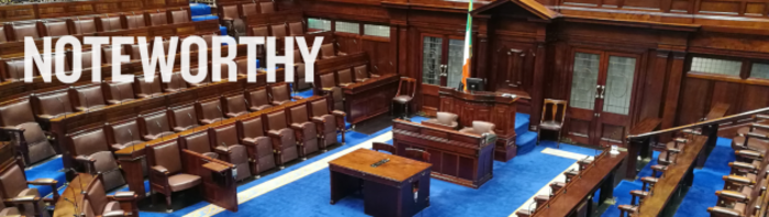 Empty D&aacute;il chamber with the Irish flag near the centre with Noteworthy written in the foreground.