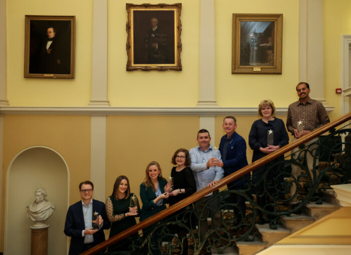 Winners of the six award categories stand in a line on a staircase in the Royal College of Physicians where the awards took place. 